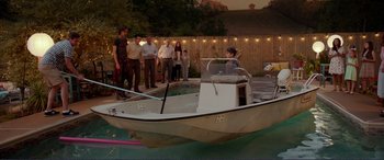 Movie still from “Diary of a Wimpy Kid: The Long Haul” (2017), directed by David Bowers – A group of people standing around a small boat; Wide shot, High angle