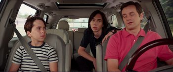 Movie still from “Diary of a Wimpy Kid: The Long Haul” (2017), directed by David Bowers – Three people sitting in the back seat of a car; Medium shot, Over the shoulder angle