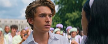 Movie still from “Do Revenge” (2022), directed by Jennifer Kaytin Robinson – A young man in front of a group of people; Close Up shot, Over the shoulder angle