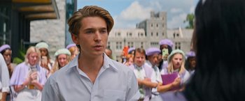 Movie still from “Do Revenge” (2022), directed by Jennifer Kaytin Robinson – A group of people standing in front of a building; Close Up shot, Over the shoulder angle