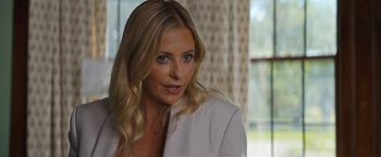 Movie still from “Do Revenge” (2022), directed by Jennifer Kaytin Robinson – A woman with long blonde hair wearing a white jacket; Close Up shot, Over the shoulder angle