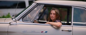 Movie still from “Do Revenge” (2022), directed by Jennifer Kaytin Robinson – A woman sitting in the driver's seat of a car; Close Up shot, Over the shoulder angle