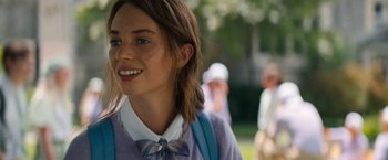 Movie still from “Do Revenge” (2022), directed by Jennifer Kaytin Robinson – A woman with a bow tie is standing outside; Close Up shot, Over the shoulder angle
