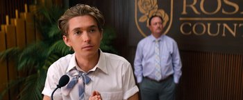 Movie still from “Do Revenge” (2022), directed by Jennifer Kaytin Robinson – A man in a white dress shirt and a man in a blue tie; Close Up shot, Over the shoulder angle