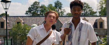 Movie still from “Do Revenge” (2022), directed by Jennifer Kaytin Robinson – Two young men standing next to each other; Medium shot, Low angle