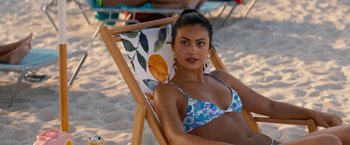 Movie still from “Do Revenge” (2022), directed by Jennifer Kaytin Robinson – A woman in a bikini sitting in a beach chair; Close Up shot, High angle