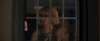 Movie still from “Do Revenge” (2022), directed by Jennifer Kaytin Robinson – A woman standing in front of a window with bars; Close Up shot, Over the shoulder angle