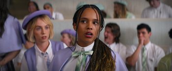 Movie still from “Do Revenge” (2022), directed by Jennifer Kaytin Robinson – A young girl in a white shirt and a green tie; Close Up shot, Low angle