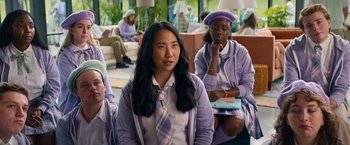 Movie still from “Do Revenge” (2022), directed by Jennifer Kaytin Robinson – A group of young people sitting in a room together; Medium shot, Over the shoulder angle