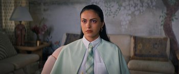 Movie still from “Do Revenge” (2022), directed by Jennifer Kaytin Robinson – A woman in a white shirt and a green tie; Close Up shot, Over the shoulder angle