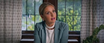 Movie still from “Do Revenge” (2022), directed by Jennifer Kaytin Robinson – A woman sitting in front of a window looking to her left; Close Up shot, Over the shoulder angle