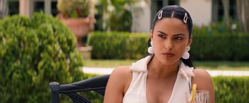 Movie still from “Do Revenge” (2022), directed by Jennifer Kaytin Robinson – A woman sitting in a chair wearing a white shirt; Close Up shot, Over the shoulder angle