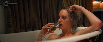 Movie still from “Do Revenge” (2022), directed by Jennifer Kaytin Robinson – A woman sitting in a bath tub drinking a glass of wine; Close Up shot, High angle