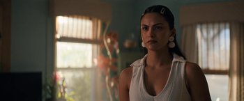 Movie still from “Do Revenge” (2022), directed by Jennifer Kaytin Robinson – A woman in a white shirt is standing in front of a window; Close Up shot, Over the shoulder angle
