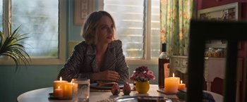 Movie still from “Do Revenge” (2022), directed by Jennifer Kaytin Robinson – A woman sitting at a table with a plate in front of her; Medium shot, Over the shoulder angle