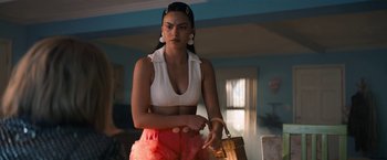 Movie still from “Do Revenge” (2022), directed by Jennifer Kaytin Robinson – A woman in a white crop top holding a knife; Medium shot, Low angle