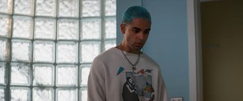 Movie still from “Do Revenge” (2022), directed by Jennifer Kaytin Robinson – A man with blue hair is standing in front of a window; Medium shot, High angle
