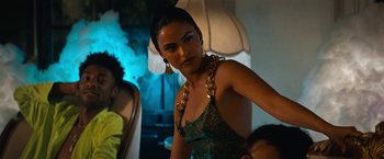 Movie still from “Do Revenge” (2022), directed by Jennifer Kaytin Robinson – A woman in a green dress with gold jewelry; Medium shot, Over the shoulder angle