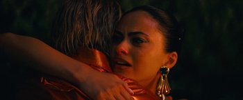 Movie still from “Do Revenge” (2022), directed by Jennifer Kaytin Robinson – A woman hugging another woman in a red dress; Close Up shot, Over the shoulder angle