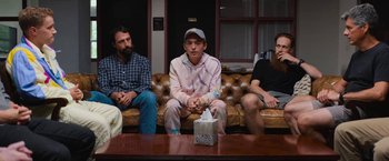 Movie still from “Do Revenge” (2022), directed by Jennifer Kaytin Robinson – A group of people sitting on a couch; Medium shot, Over the shoulder angle