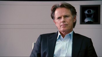 Movie still from “Dinner for Schmucks” (2010), directed by Jay Roach – A person wearing a suit and tie; Close Up shot, Over the shoulder angle