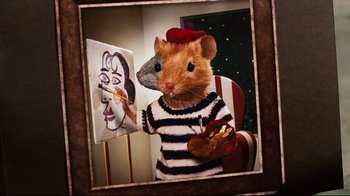 Movie still from “Dinner for Schmucks” (2010), directed by Jay Roach – A mouse wearing a sweater and hat is painting a picture; Close Up shot, High angle