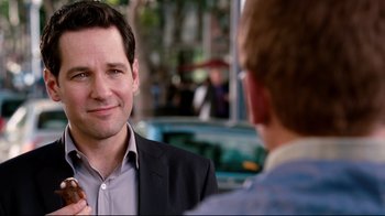 Movie still from “Dinner for Schmucks” (2010), directed by Jay Roach – A man in a business suit talking to another man in a business suit; Close Up shot, Over the shoulder angle