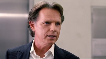 Movie still from “Dinner for Schmucks” (2010), directed by Jay Roach – A person wearing a suit and tie; Close Up shot, Over the shoulder angle