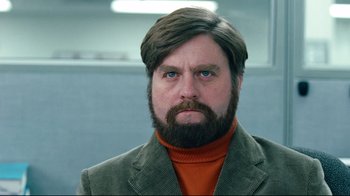 Movie still from “Dinner for Schmucks” (2010), directed by Jay Roach – A person with a beard wearing a suit; Close Up shot, Low angle
