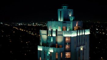 Movie still from “Dinner for Schmucks” (2010), directed by Jay Roach – A building that is lit up at night time; Extreme Wide shot, High angle