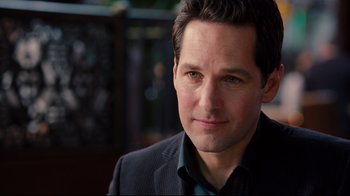 Movie still from “Dinner for Schmucks” (2010), directed by Jay Roach – A person wearing a suit and tie; Close Up shot, Over the shoulder angle