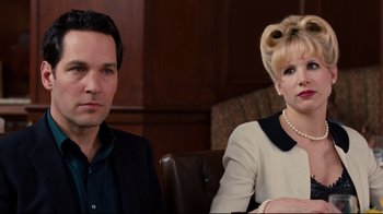 Movie still from “Dinner for Schmucks” (2010), directed by Jay Roach – A man and a woman sitting next to each other; Close Up shot, Over the shoulder angle