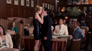 Movie still from “Dinner for Schmucks” (2010), directed by Jay Roach – A man and a woman kissing in front of a table of diners; Wide shot, Over the shoulder angle