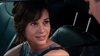 Movie still from “Dinner for Schmucks” (2010), directed by Jay Roach – A woman sitting in the back seat of a car; Close Up shot, Over the shoulder angle
