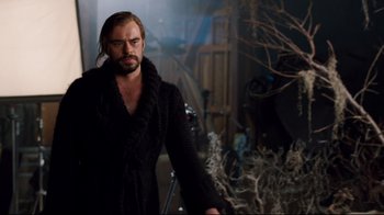 Movie still from “Dinner for Schmucks” (2010), directed by Jay Roach – A man with a beard and a black coat; Medium shot, Over the shoulder angle