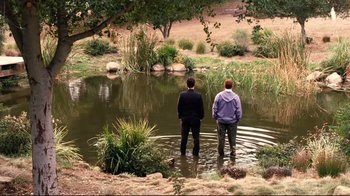 Movie still from “Dinner for Schmucks” (2010), directed by Jay Roach – Two men standing in a pond looking at the water; Extreme Wide shot, High angle