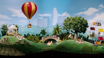 Movie still from “Dinner for Schmucks” (2010), directed by Jay Roach – A scene with a balloon and a bridge in the middle of a park; Extreme Wide shot, High angle