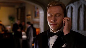 Movie still from “Dinner for Schmucks” (2010), directed by Jay Roach – A man in a tuxedo talking on a cell phone; Close Up shot, Low angle