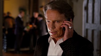 Movie still from “Dinner for Schmucks” (2010), directed by Jay Roach – An older man talking on a cell phone while wearing a ring; Close Up shot, Over the shoulder angle