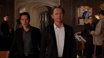 Movie still from “Dinner for Schmucks” (2010), directed by Jay Roach – A man in a black suit and a man in a white shirt; Medium shot, Over the shoulder angle