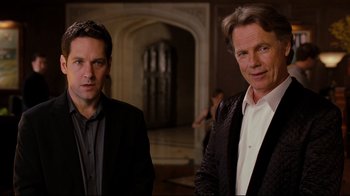 Movie still from “Dinner for Schmucks” (2010), directed by Jay Roach – Two men standing next to each other in front of an archway; Medium shot, Over the shoulder angle