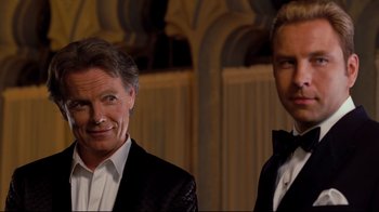 Movie still from “Dinner for Schmucks” (2010), directed by Jay Roach – A couple of men standing next to each other in tuxedos; Close Up shot, Over the shoulder angle