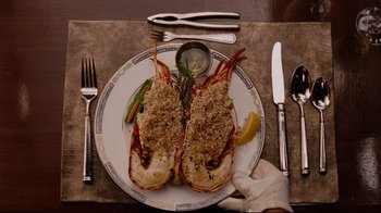Movie still from “Dinner for Schmucks” (2010), directed by Jay Roach – A plate with a lobster and a bunch of utensils on it; Close Up shot, Overhead angle