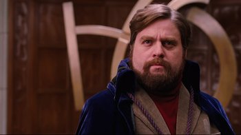 Movie still from “Dinner for Schmucks” (2010), directed by Jay Roach – A person with a beard wearing a jacket; Close Up shot, Low angle