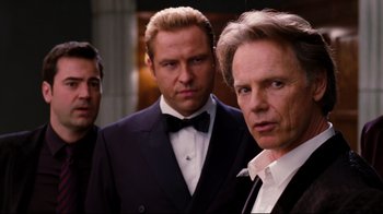 Movie still from “Dinner for Schmucks” (2010), directed by Jay Roach – A group of men standing next to each other in tuxedos; Medium shot, Over the shoulder angle