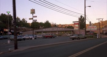Movie still from “Dirty Mary Crazy Larry” (1974), directed by John Hough – A grocery store with a lot of cars parked in front of it; Extreme Wide shot, High angle