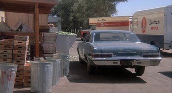 Movie still from “Dirty Mary Crazy Larry” (1974), directed by John Hough – An old car parked on the side of the street; Wide shot, Over the shoulder angle