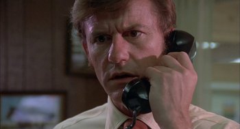 Movie still from “Dirty Mary Crazy Larry” (1974), directed by John Hough – An older man holding a phone up to his ear; Close Up shot, Low angle