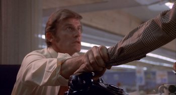 Movie still from “Dirty Mary Crazy Larry” (1974), directed by John Hough – A man holding onto the handle of an electric guitar; Close Up shot, Low angle