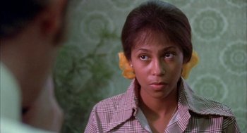 Movie still from “Dirty Mary Crazy Larry” (1974), directed by John Hough – A young woman with yellow flowers in her hair; Close Up shot, Over the shoulder angle